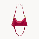 Fuchsia pebbled leather Consuela Kyle bag with gold hardware and convertible straps.