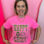 Hot pink graphic tee with green lettering, striped accents, and shamrock detail on soft cotton fabric
