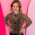 Sheer leopard mesh top with kitty print, long sleeves, and stretchy fabric for bold layered styling.