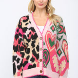 Oversized cardigan with heart, leopard, and mixed patterns in pink, green, beige, and black.