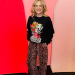 Black graphic sweatshirt with His Way Is Better phrase and bright leopard-accented design.