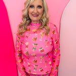 Holiday drinks print mesh top with lettuce hems and mock neckline, perfect for festive layering