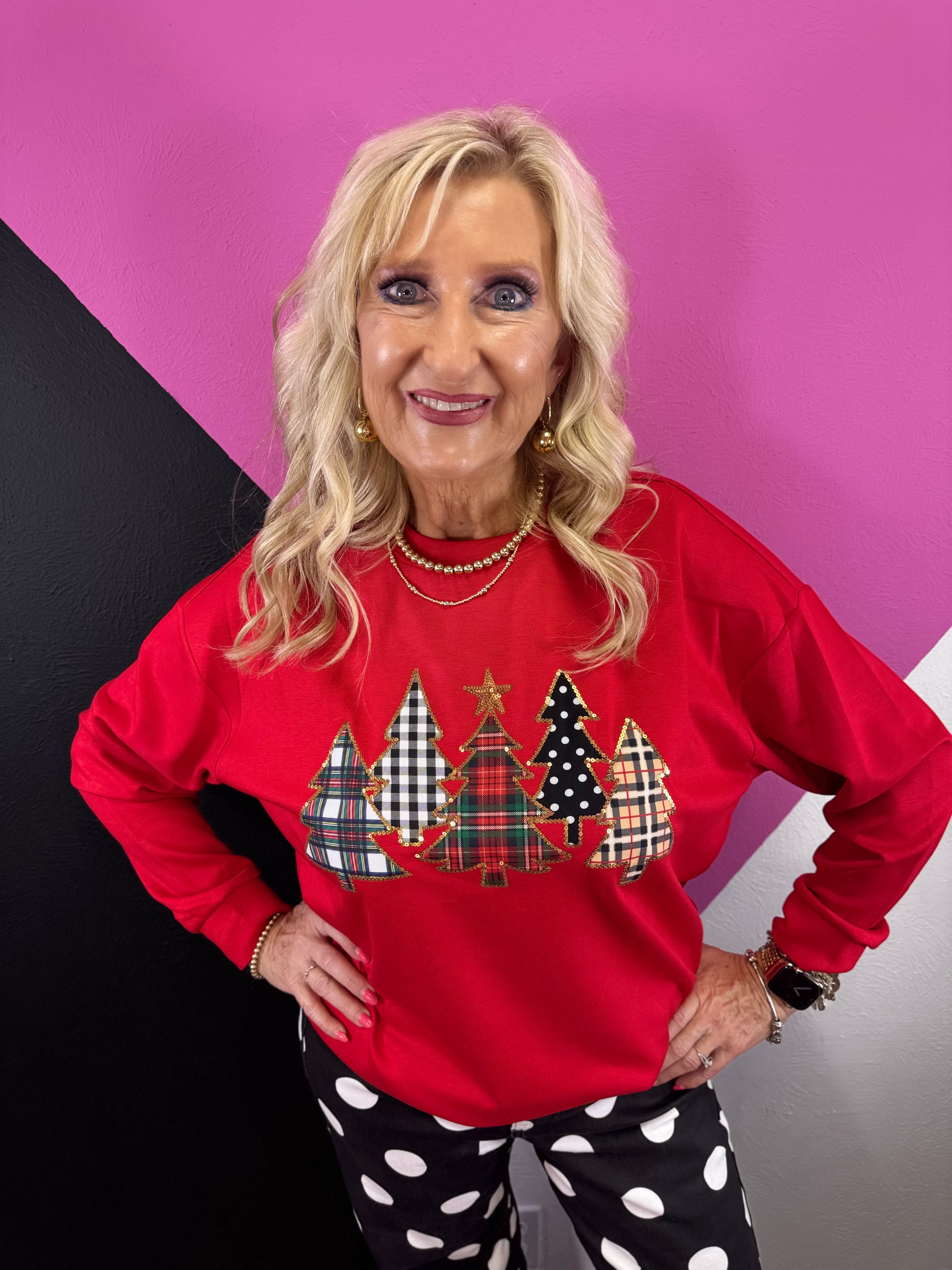 Red Christmas pullover with five patterned tree appliqués, shimmering sequins and gold star.