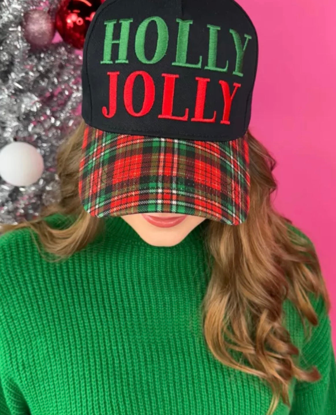 Black hat with “Holly Jolly” red and green embroidery and red-green-black-white plaid bill.
