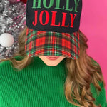 Black hat with “Holly Jolly” red and green embroidery and red-green-black-white plaid bill.