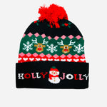 Black knit beanie with reindeer, snowflakes, red pom pom, and “Holly Jolly” snowman cuff.