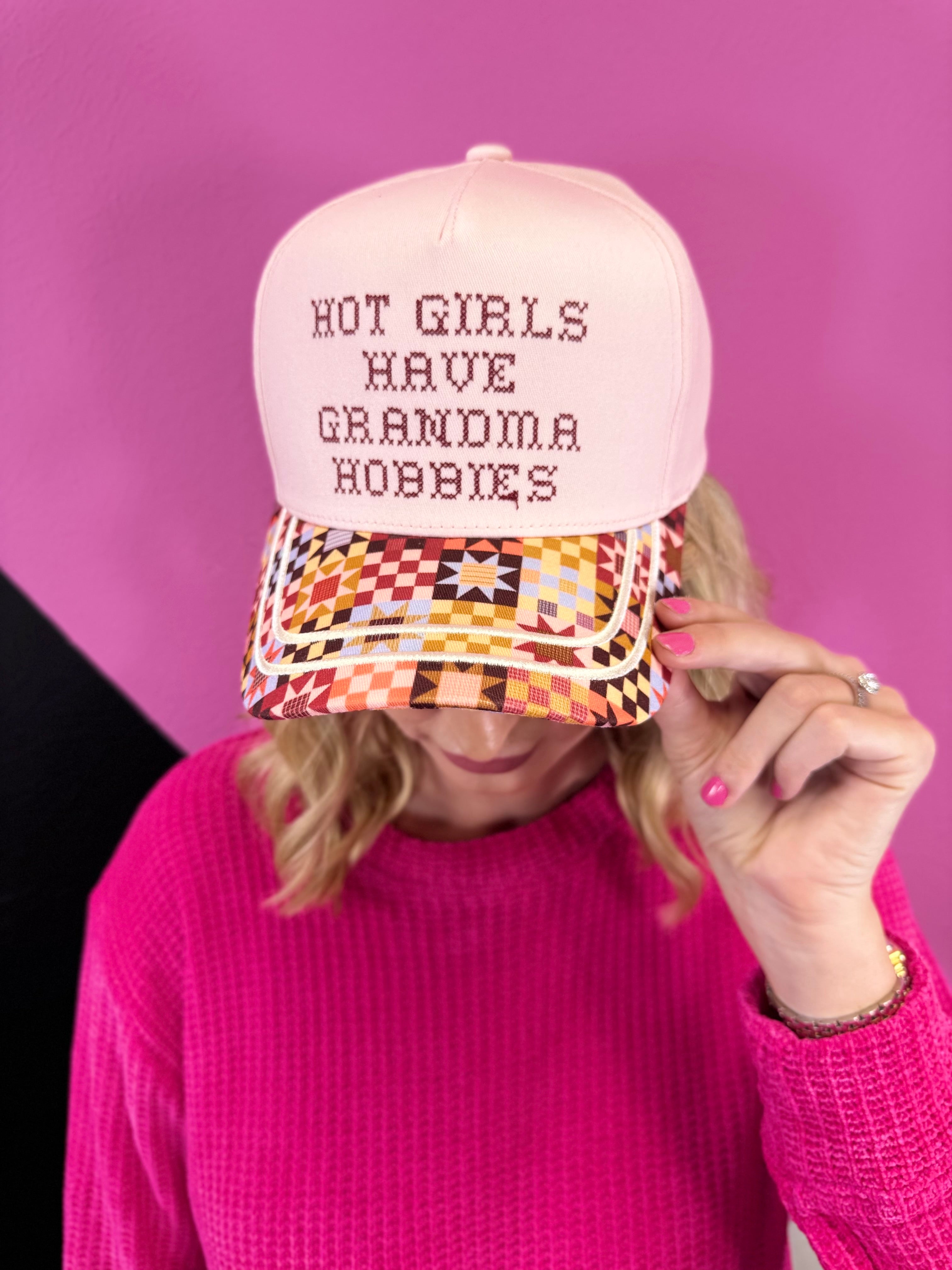 Blush pink hat with Grandma Hobbies lettering, colorful patchwork quilt bill, and gold piping.