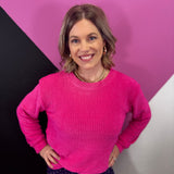 Hot pink chenille waffle knit sweater with round neckline.