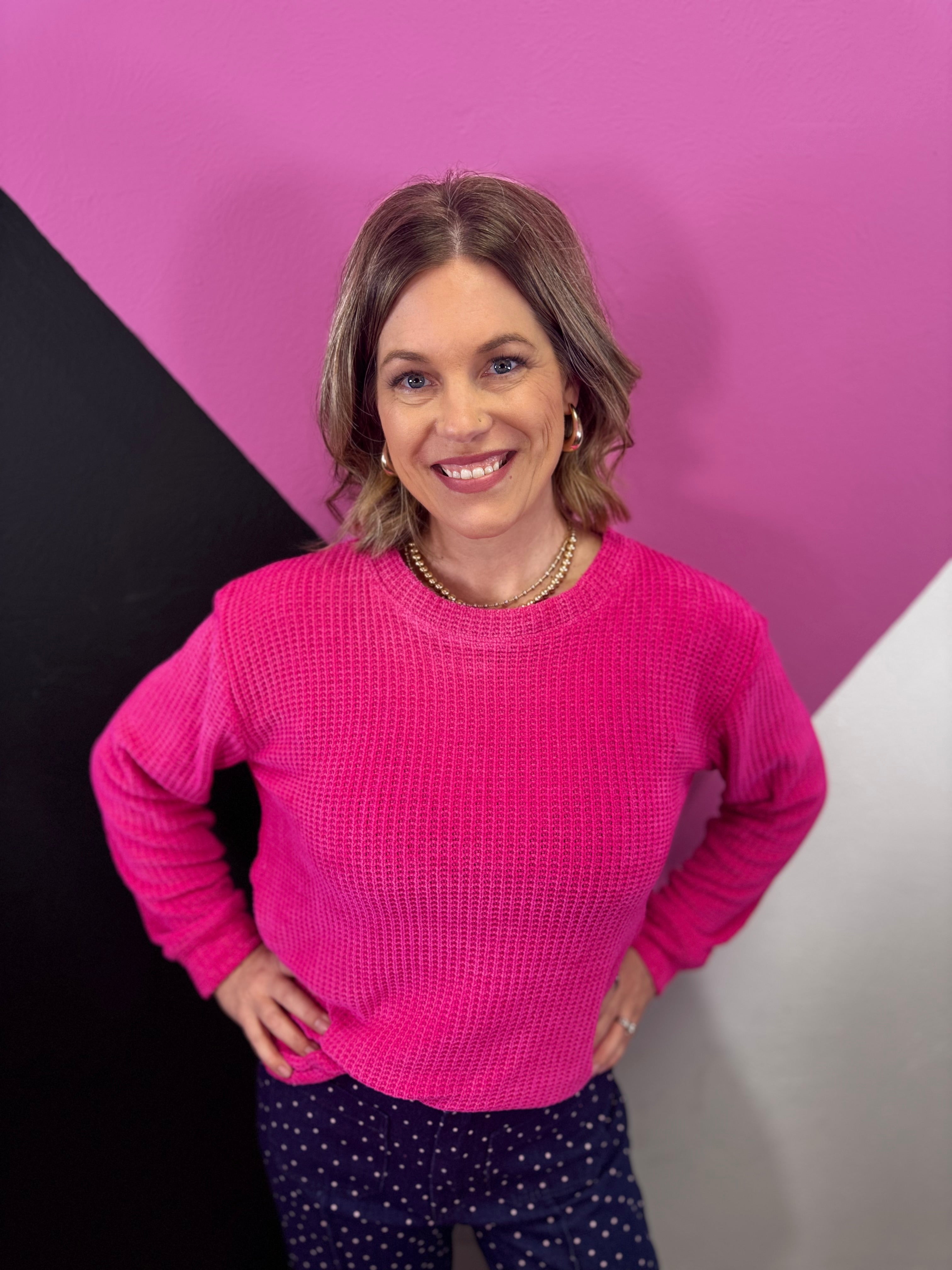 Hot pink chenille waffle knit sweater with round neckline.