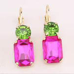 Hot pink rectangular rhinestone earrings with green stud and gold settings.