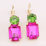 Hot pink rectangular rhinestone earrings with green stud and gold settings.