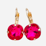 Lightweight gold tone earrings with faceted fuchsia pink gemstone drops.
