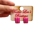 Glossy hot pink stud earrings with two vertical rows of sparkling rhinestones.