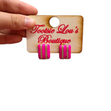 Glossy hot pink stud earrings with two vertical rows of sparkling rhinestones.