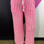 Hot pink and white vertical striped ribbed lounge pants with drawstring waist.