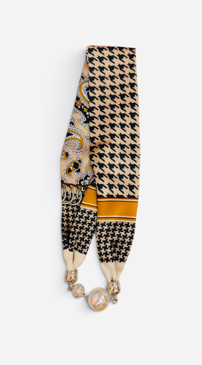 Houndstooth paisley scarf necklace with golden accents, oversized pearl, and sparkling magnetic closure.