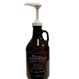 Reusable House of Cottonwood detergent bottle with sleek design for stylish, sustainable laundry room organization.