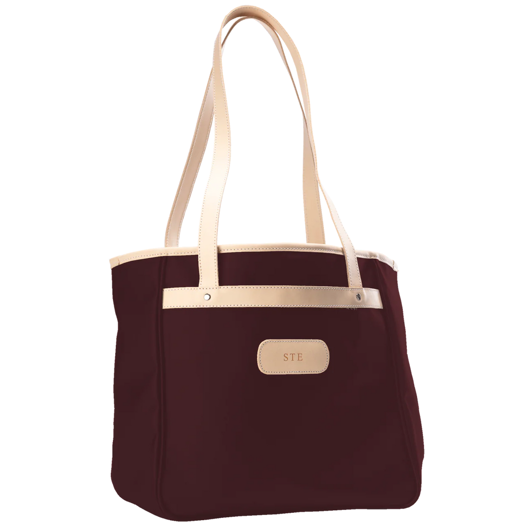 Jon Hart Amelia Tote in burgundy coated canvas with natural leather trim, padded laptop sleeve, trolley sleeve, and spacious interior pockets
