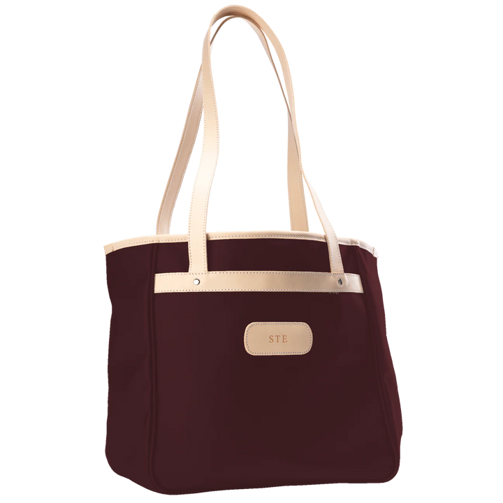 Jon Hart Amelia Tote in burgundy coated canvas with natural leather trim, padded laptop sleeve, trolley sleeve, and spacious interior pockets