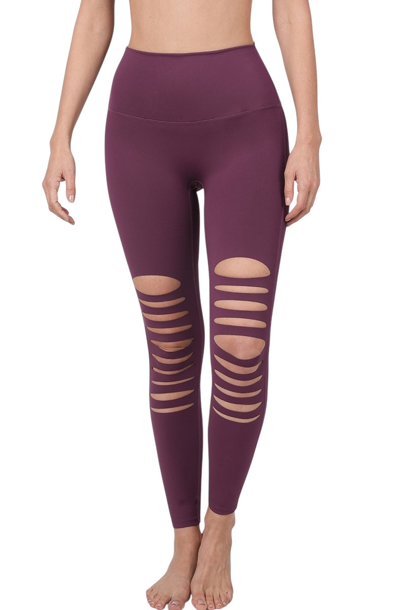 Eggplant colored stretchy leggings with destroyed front cutouts.