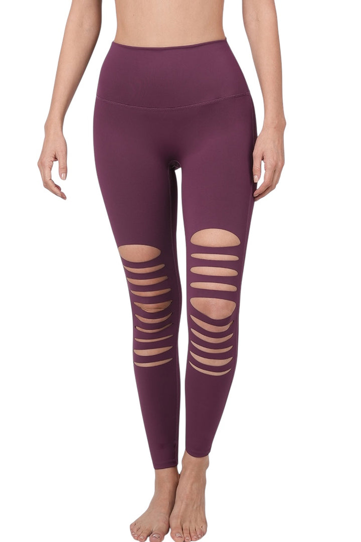 Eggplant colored stretchy leggings with destroyed front cutouts.