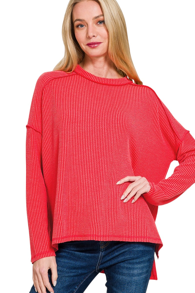 Red ribbed long sleeve top with outward seam and raw hemline 
