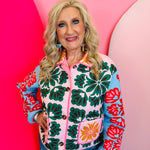 Cropped quilted floral jacket with collar, button front, and colorful pink, green, red, and blue pattern.