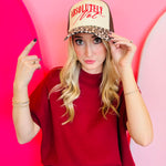 Cream and leopard print hat with red embroidered “Absolutely Not” lettering.