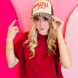 Cream and leopard print hat with red embroidered “Absolutely Not” lettering.