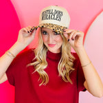 Leopard print cap with “He Still Does Miracles” embroidered on the front.