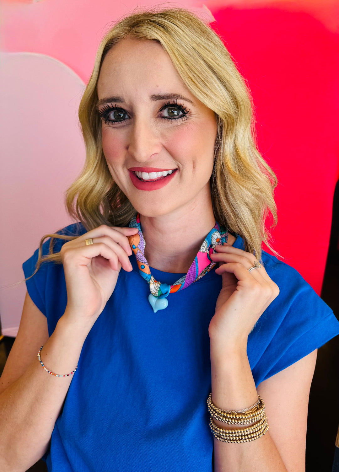 Close-up of model wearing the Blue Scarf Blue Heart Charm Necklace, featuring a soft blue printed scarf and glossy baby blue heart pendant—lightweight, adjustable, and perfect for adding a playful pop of color and charm to any outfit.