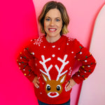 Red reindeer sweater with snowflakes, sparkling eyes, red nose, and sleeve lights for festive flair.