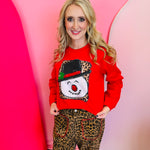 Red snowman sweatshirt with leopard print background and holly-trimmed black hat