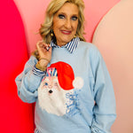 Light blue sweatshirt with winking Santa graphic, candy-striped hat, and fluffy pom detail.