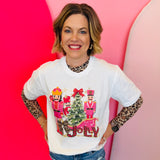 White tee with pink nutcrackers, leopard “Jolly” text, red bow, and festive Christmas tree design.