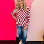 Maroon and white checkered quarter-zip pullover with collar and kangaroo pocket.