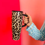 40oz leopard print tumbler with flip-straw, handle, screw-on lid, and car cup holder compatibility.