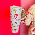 40oz tumbler with spring bow design, flip-straw lid, handle, and car cup holder compatibility.