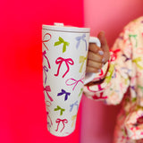 40oz tumbler with spring bow design, flip-straw lid, handle, and car cup holder compatibility.