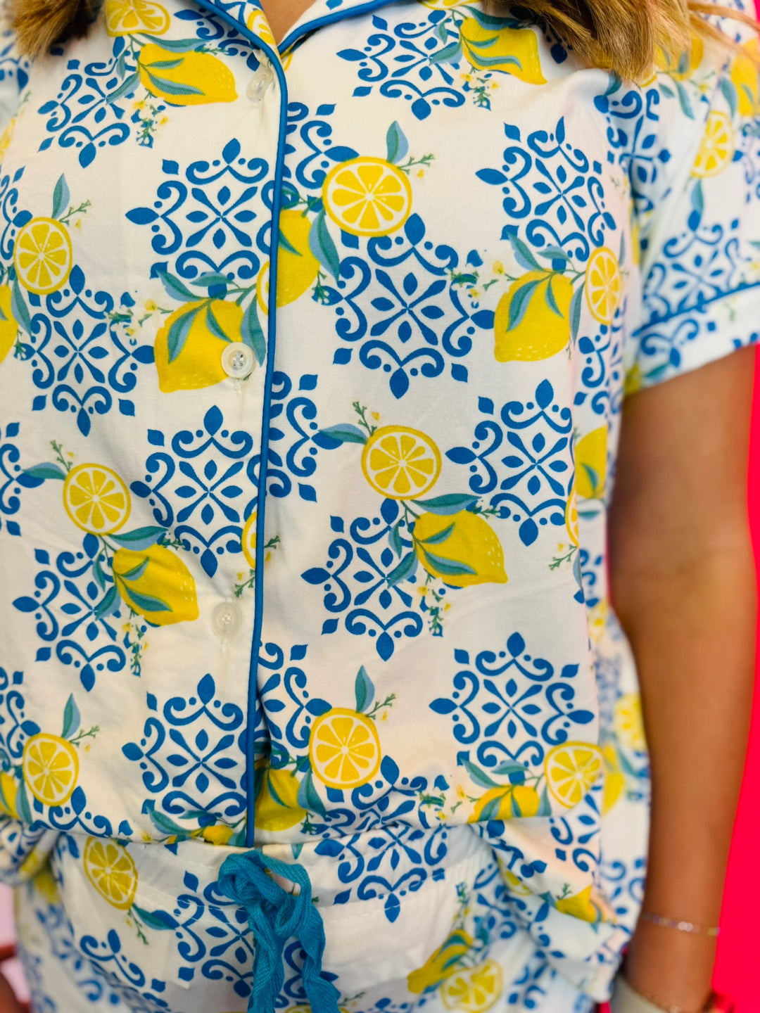 Detailed view of soft fabric texture, button front closure, and contrast piping.