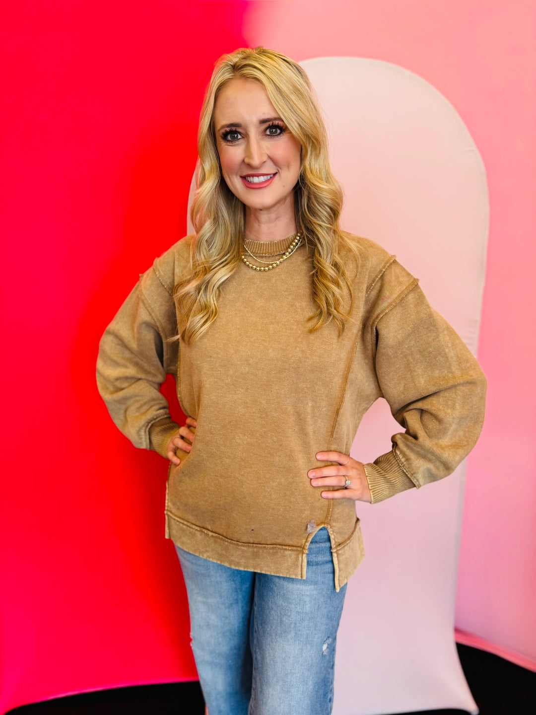 Camel acid wash fleece sweatshirt with exposed seams, relaxed fit, and side slits.