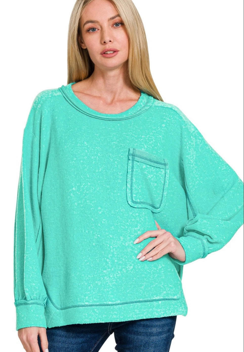 Plus-size turquoise brushed knit sweater with hi-low hem and side slits, shown flat to highlight soft texture and relaxed fit.