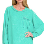 Plus-size turquoise brushed knit sweater with hi-low hem and side slits, shown flat to highlight soft texture and relaxed fit.