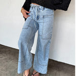 Light denim boho-inspired jeans with tie waist and front panel pockets, ideal for summer styling.