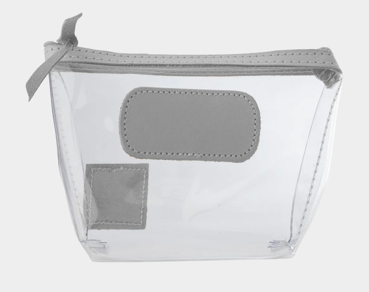 Jon Hart Airport Chico clear TSA-compliant travel pouch with steel Natural Leather trim, flat bottom, and zippered brass closure—perfect for carrying 3oz liquids and travel essentials.