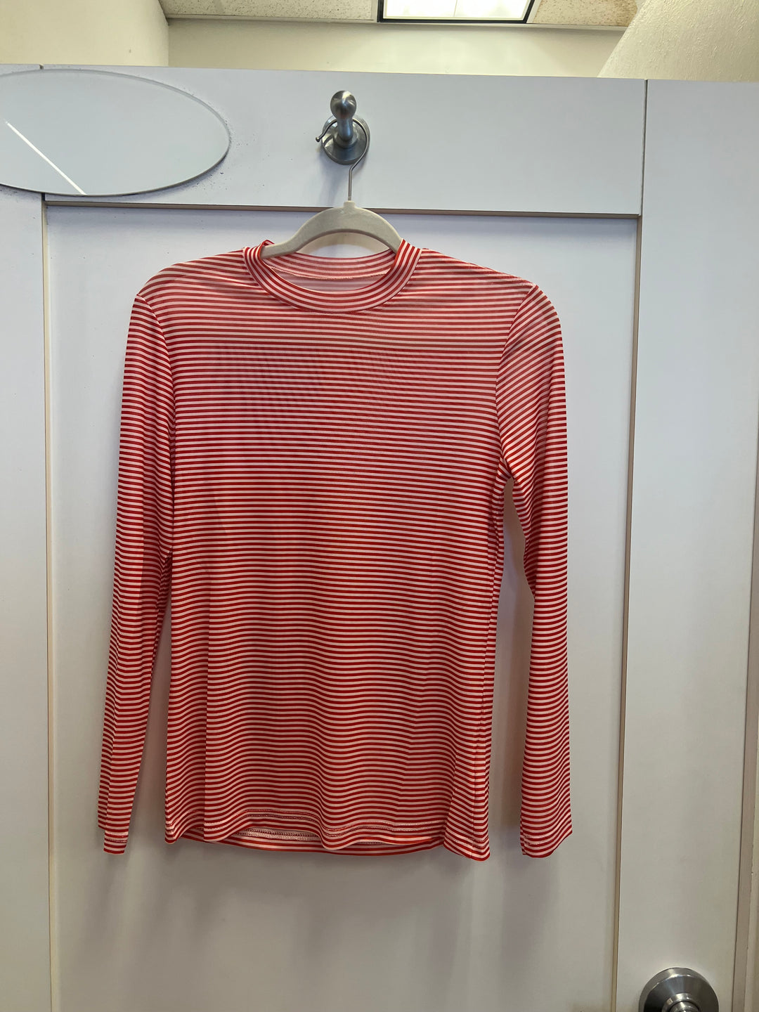 Red Striped Mesh Top with bright red and white horizontal stripes, long sleeves, crewneck, and breathable mesh fabric made of 95% polyester and 5% spandex.