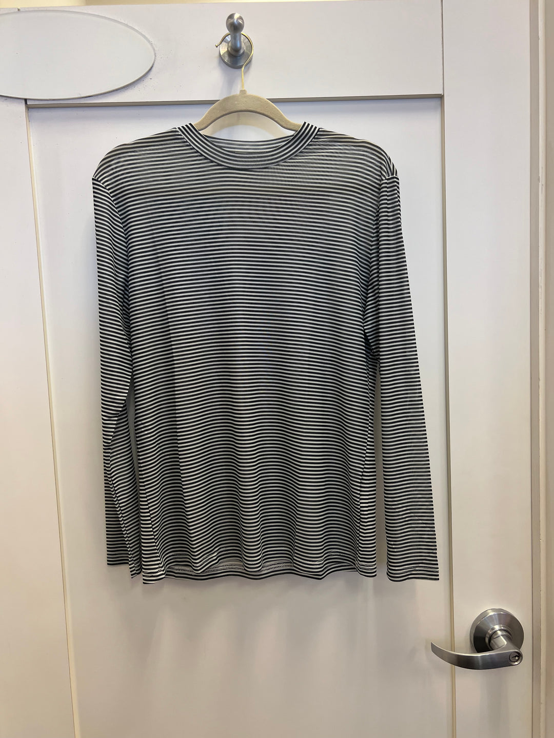 Black Striped Mesh Top with black and white horizontal stripes, long sleeves, crewneck, and breathable mesh fabric made of 95% polyester and 5% spandex.