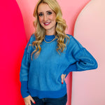 Ocean blue two-tone sweater with exposed seams, hi-low hem, and contrasting ribbed trim.