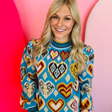 Sweater with colorful heart and geometric patterns, long balloon sleeves, and striped ribbed trim.