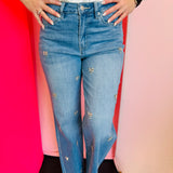 High-rise wide-leg jeans with rhinestone bow embellishments.